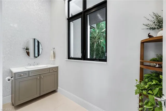 a bathroom with a sink a toilet and mirror