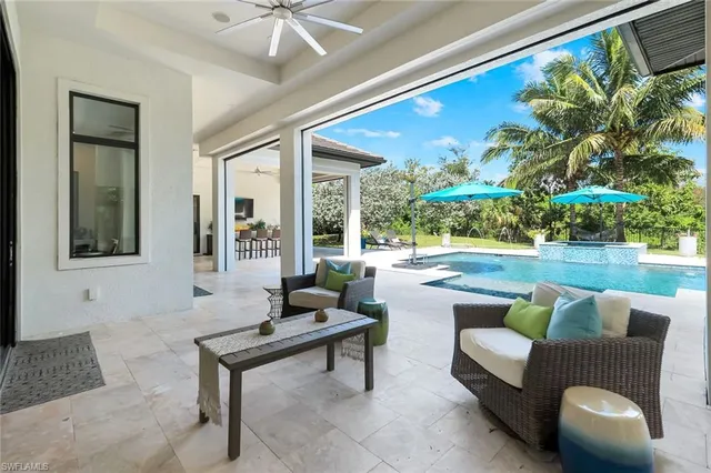 a building outdoor space with patio furniture and potted plants