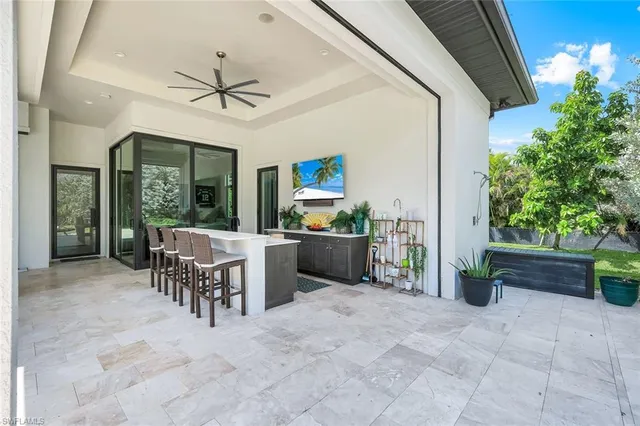 a kitchen with a sink and large windows