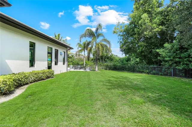 a view of a patio with table and chairs potted plants with wooden floor and fence