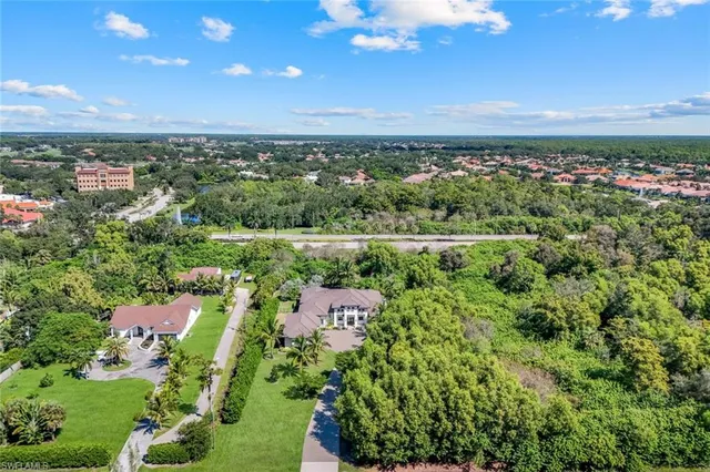 a front view of a house with garden patio and swimming pool