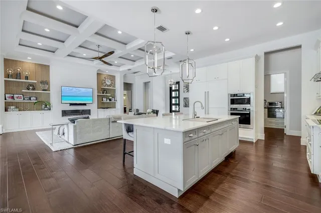 a front view of a house with a yard and potted plants