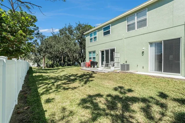 a swimming pool with outdoor seating and yard