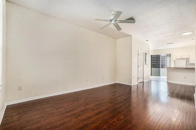 a view of empty room with wooden floor