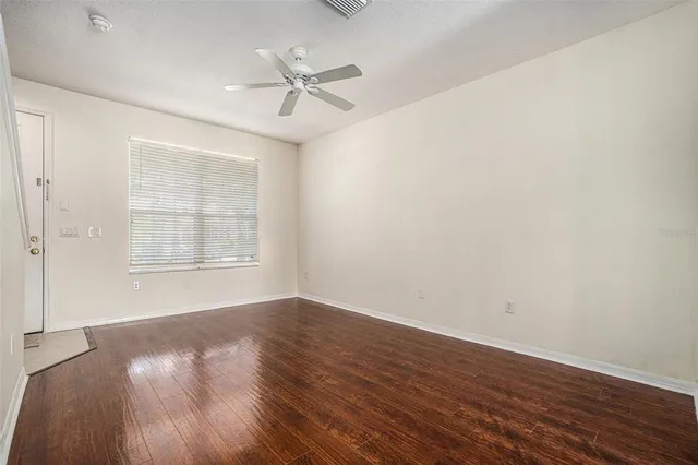 wooden floor in an empty room with a window