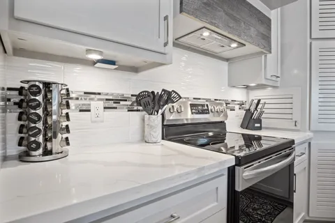 a kitchen with a stove and cabinets