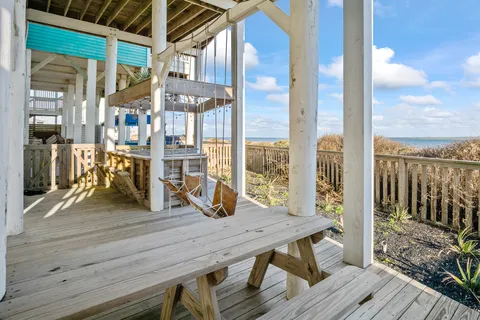 a view of a wooden deck with a table and chairs