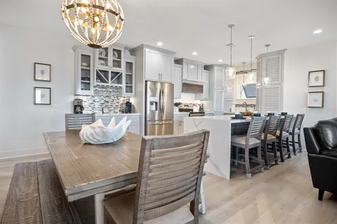 a view of a dining room with furniture and a chandelier