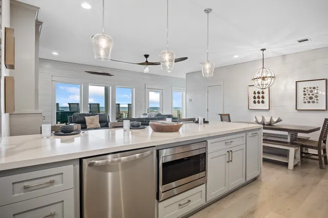 a kitchen with stainless steel appliances kitchen island a large island in the center