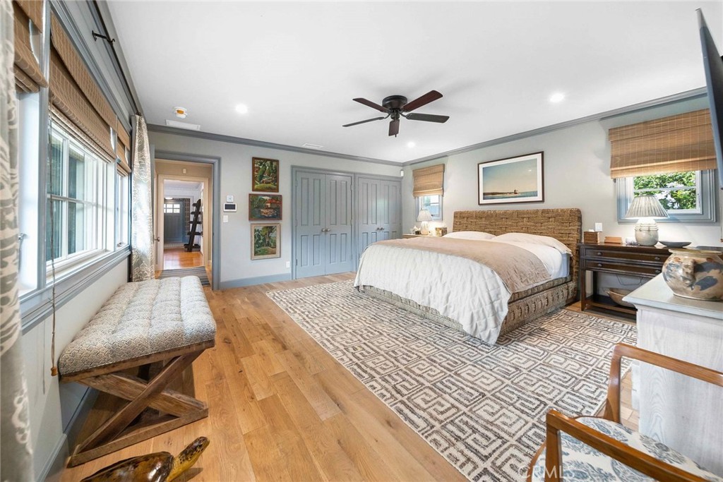 16544 Greenleaf Street Encino, CA 91436 - Photo 12 of 23 a spacious bedroom with a large bed a chandelier and windows