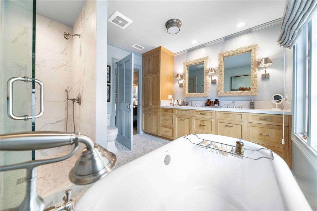 16544 Greenleaf Street Encino, CA 91436 - Photo 16 of 23 a room with a sink a bed and a mirror