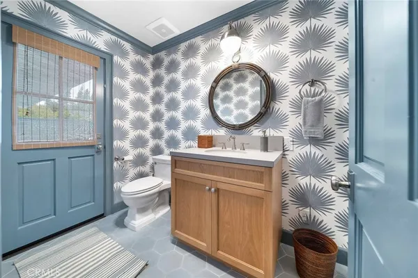 a bathroom with a toilet a sink and mirror