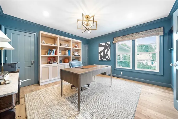a view of a workspace with furniture window and wooden floor