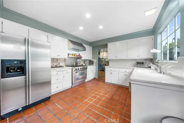 a kitchen with stainless steel appliances a stove sink and microwave