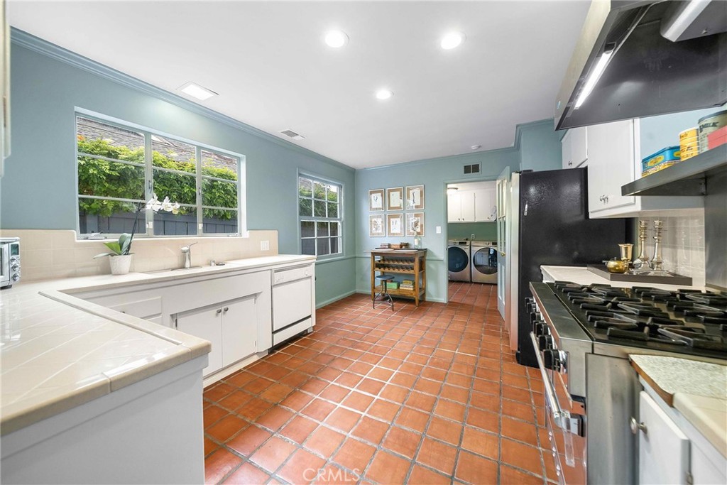 16544 Greenleaf Street Encino, CA 91436 - Photo 9 of 23 a kitchen with stainless steel appliances a stove sink and microwave