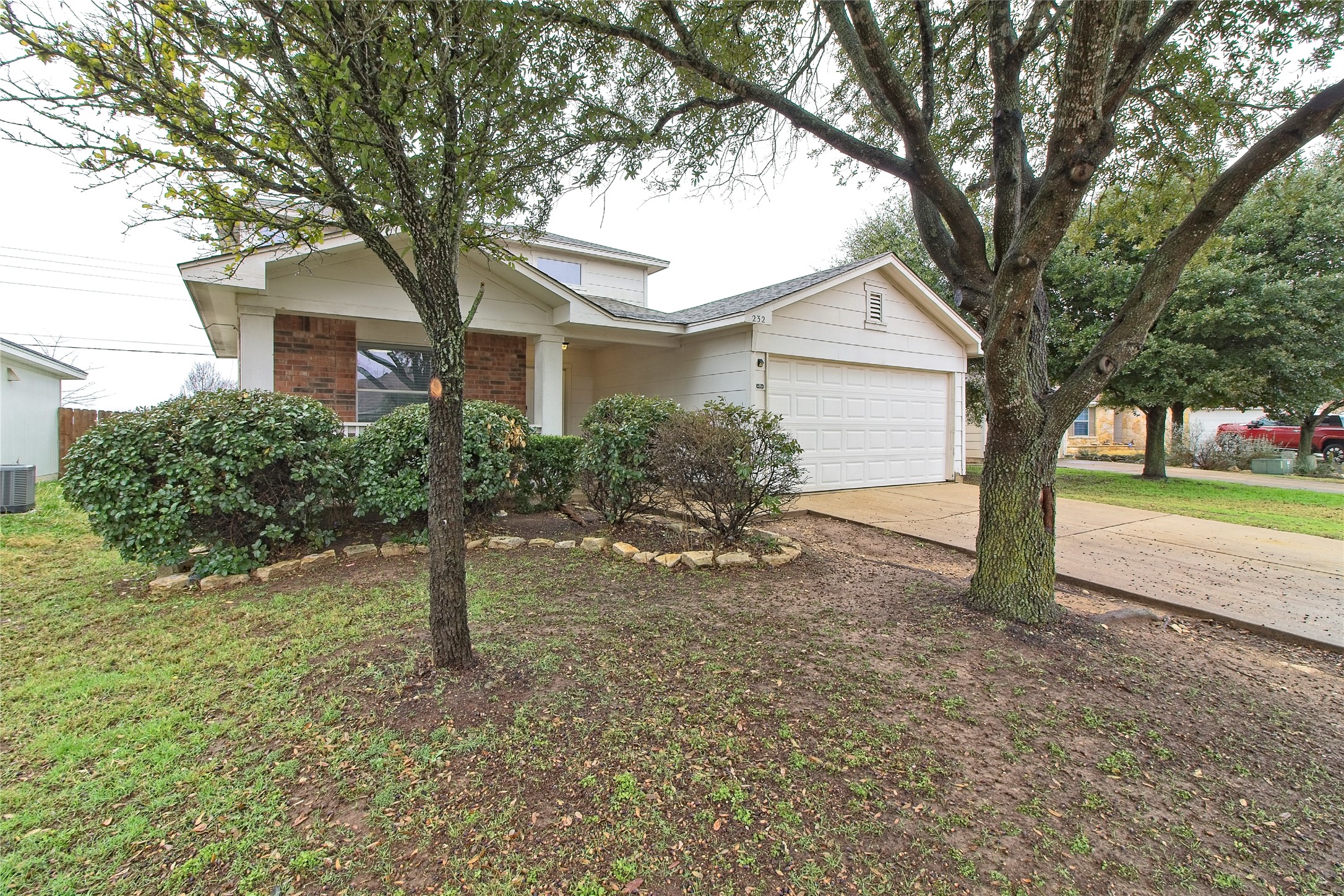 232 Brickyard Lane Jarrell, TX 76537 - Photo 3 of 31 A classic ranch home, graced by mature trees and a neatly trimmed landscape.
