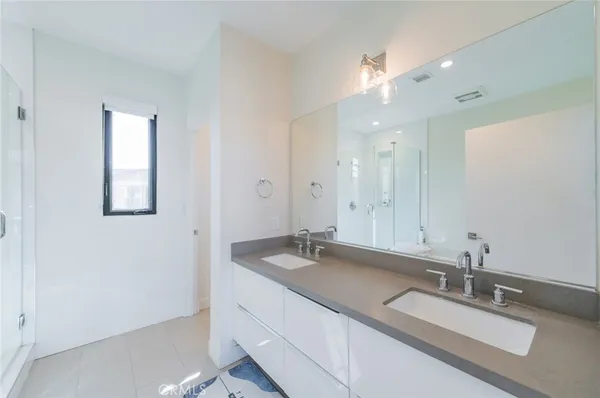 a bathroom with a sink double vanity and a mirror