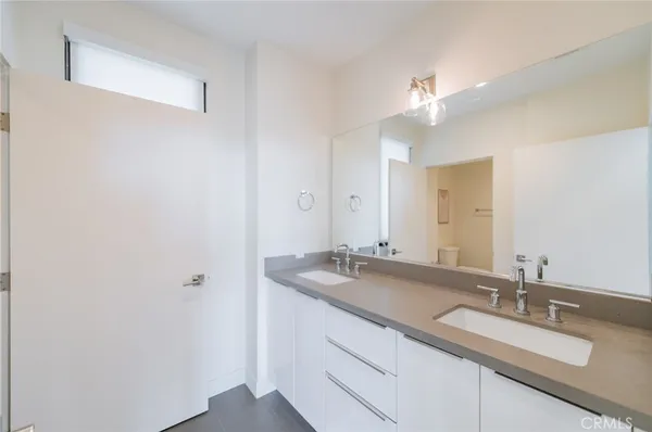a bathroom with a double vanity sink and a mirror