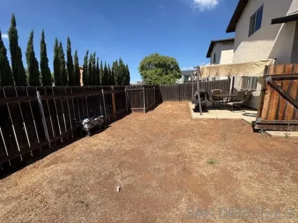 a view of a backyard with sitting area