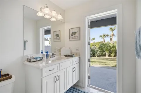 a bathroom with a shower a sink and a mirror