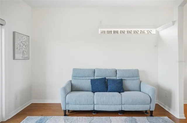 a living room with furniture kitchen view and a fireplace