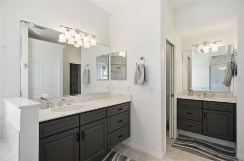 a living room with furniture a flat screen tv and wooden floor