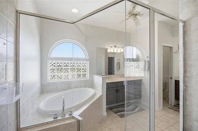 a living room with furniture a fireplace and a large window