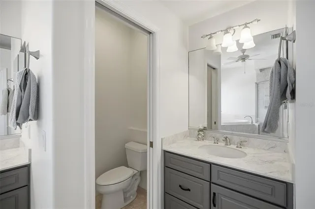 a view of a dining room and livingroom with furniture wooden floor a chandelier