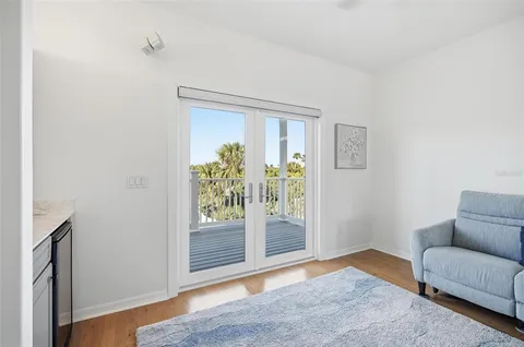 a kitchen with stainless steel appliances kitchen island granite countertop a refrigerator a stove a oven and a dining table with wooden floor