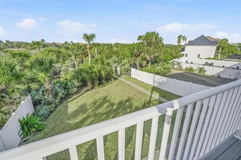 a kitchen with stainless steel appliances granite countertop a refrigerator a stove and a sink with wooden floors