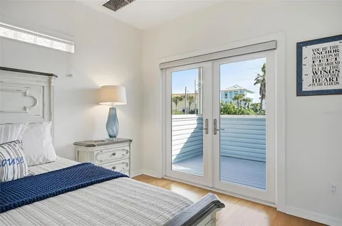 a kitchen with stainless steel appliances granite countertop a refrigerator a stove and a sink with wooden floors