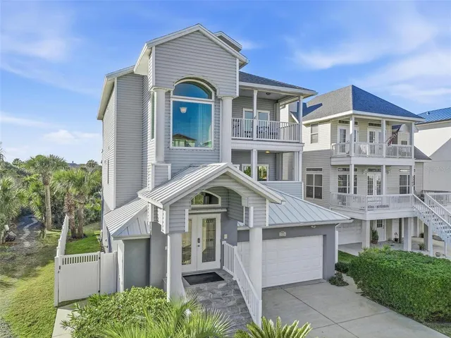 a view of a hallway with wooden floor and a bathroom