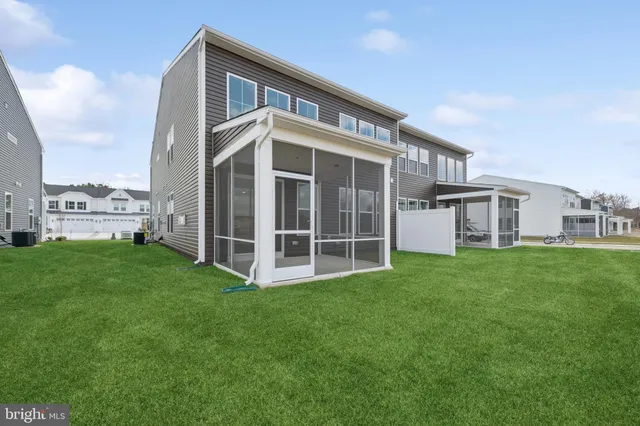 a view of a house with a yard and sitting area