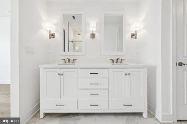 a bathroom with a sink vanity and mirror