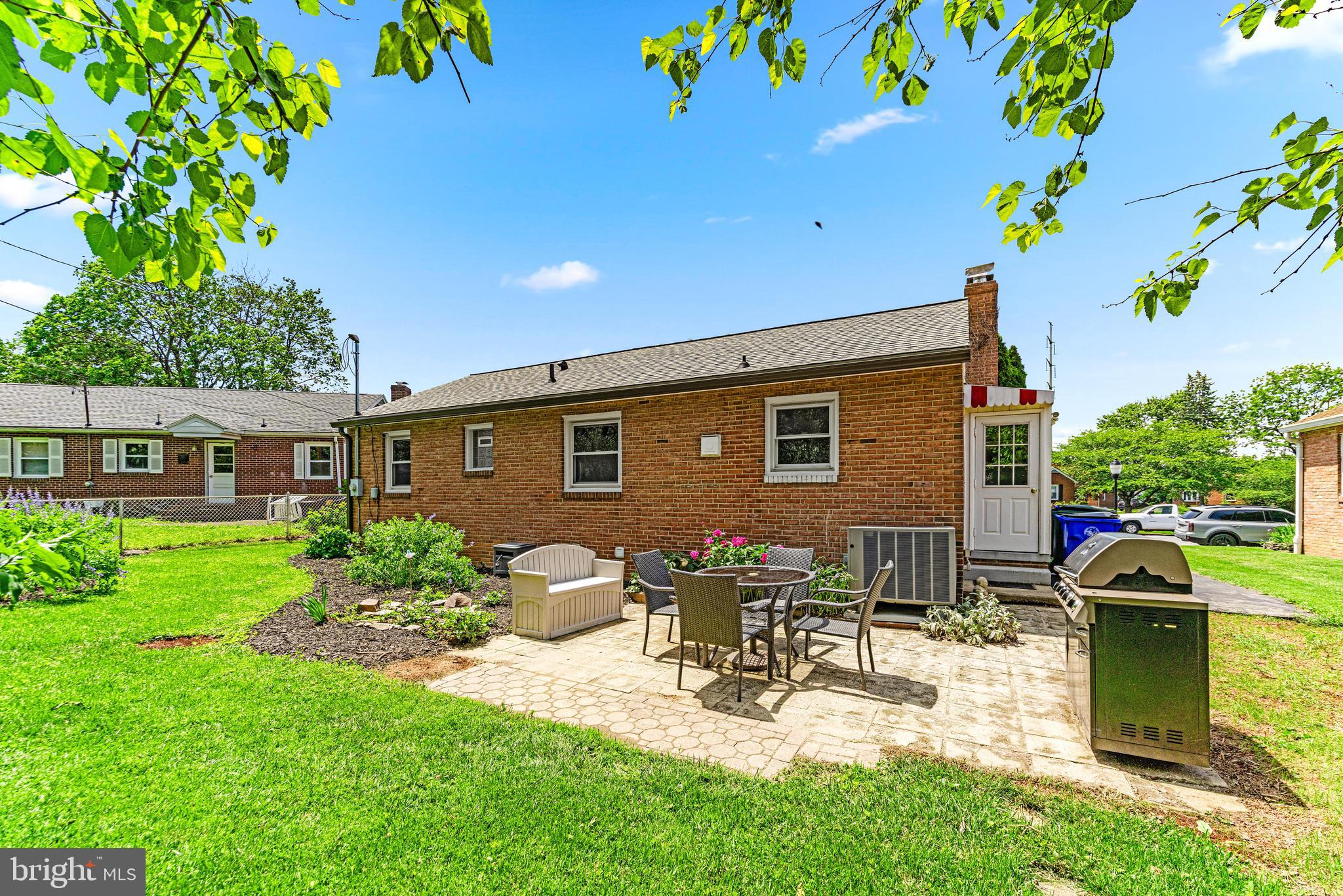 922 Cherokee Trail Frederick, MD 21701 - Photo 35 of 40 a view of a patio with table and chairs potted plants and large tree