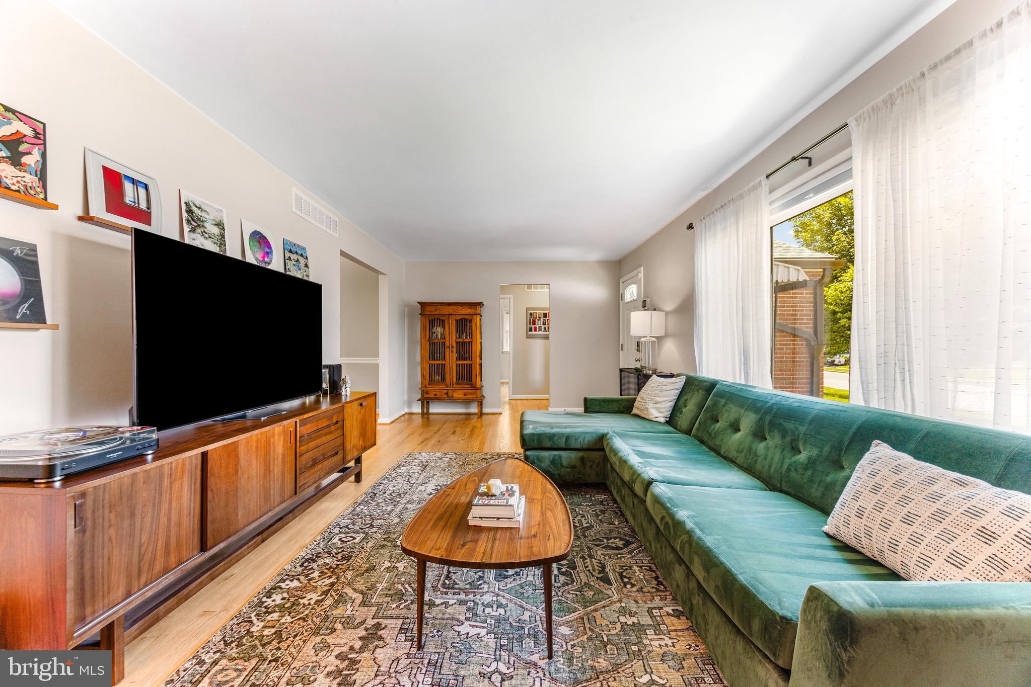 922 Cherokee Trail Frederick, MD 21701 - Photo 8 of 40 a living room with furniture and a flat screen tv