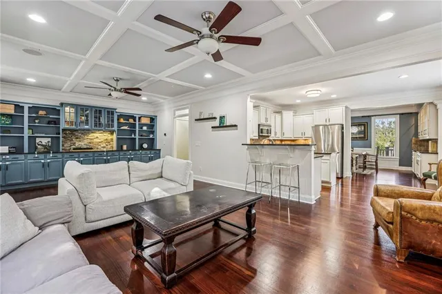 a living room with furniture and kitchen view
