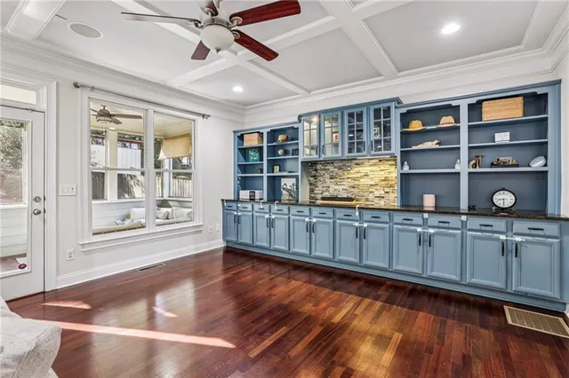 a open hall with wooden floor and windows