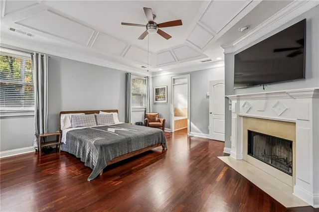 a spacious bedroom with a bed and a flat screen tv