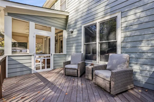 a view of a patio with couches and wooden floor