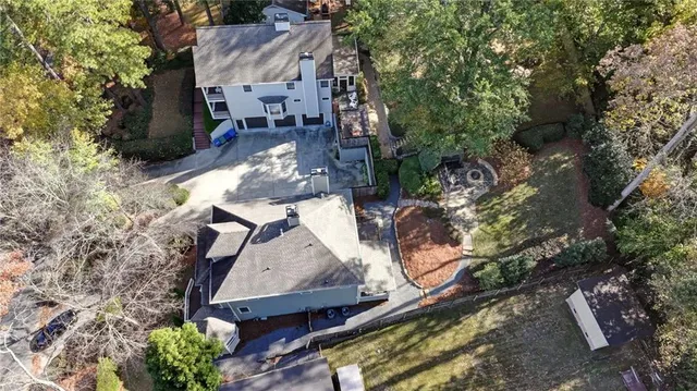 an aerial view of a house with a yard and lake view