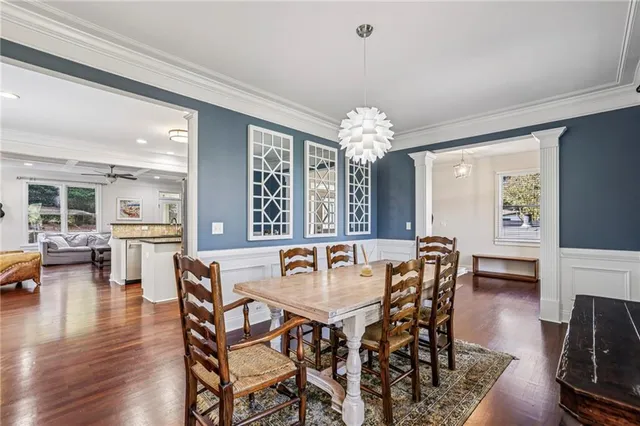 a view of a dining room with furniture and wooden floor