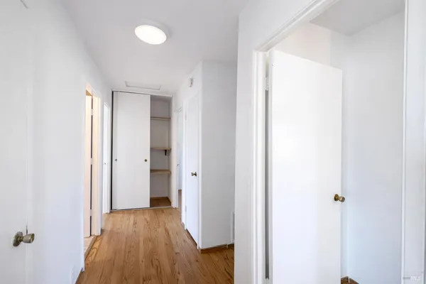 a view of a hallway with wooden floor