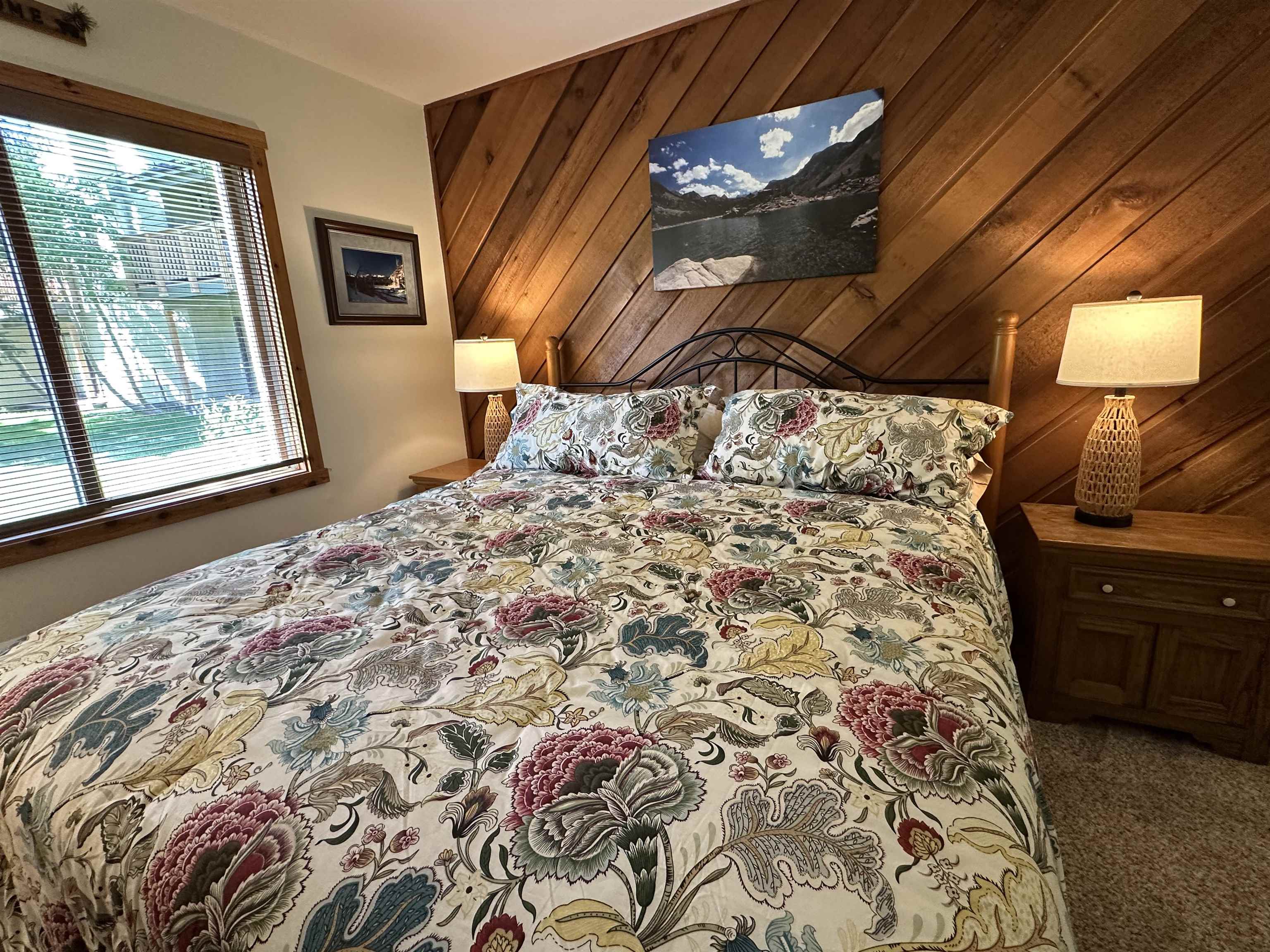 315 Fascination, Unit 315 Mammoth Lakes, CA 93546 - Photo 7 of 44 Bedroom featuring a wood-paneled accent wall, a window with wood-finish blinds, and a built-in headboard