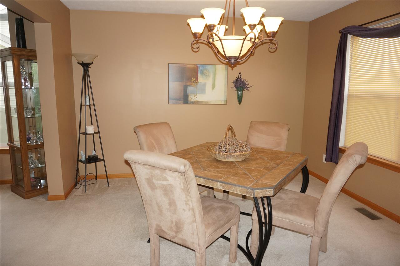 1439 Rock Island Road Davis Junction, IL 61020 - Photo 9 of 25 a view of a dining room with furniture and a chandelier
