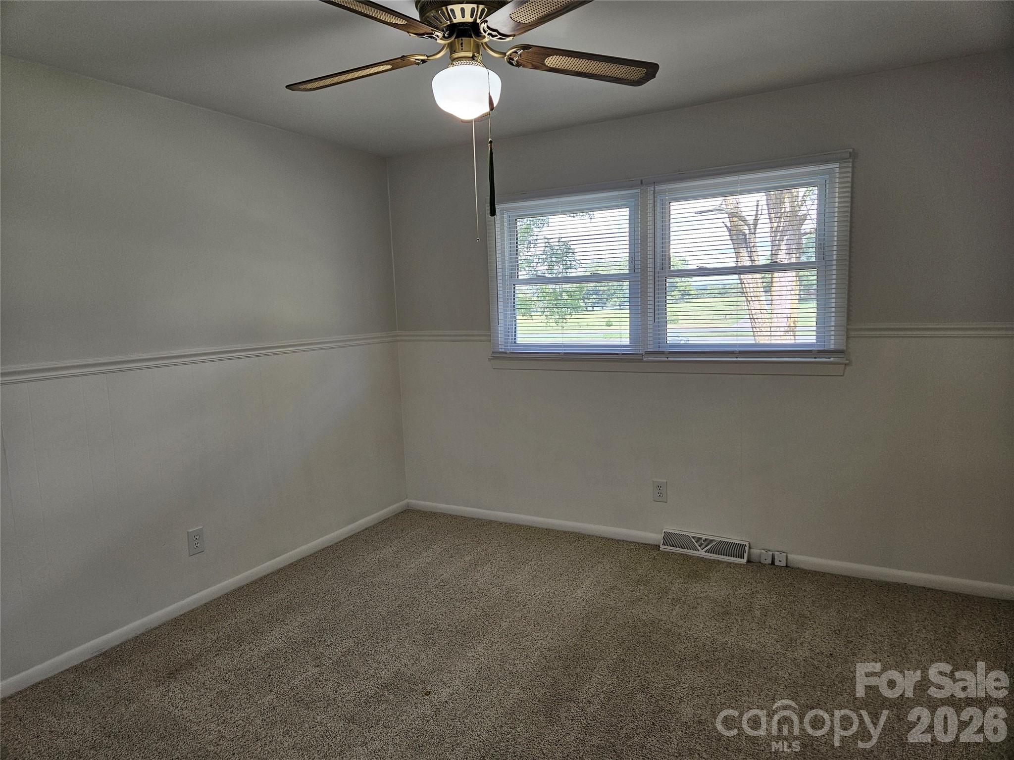 20402 Norton Road Albemarle, NC 28001 - Photo 25 of 34 an empty room with a window and a fan