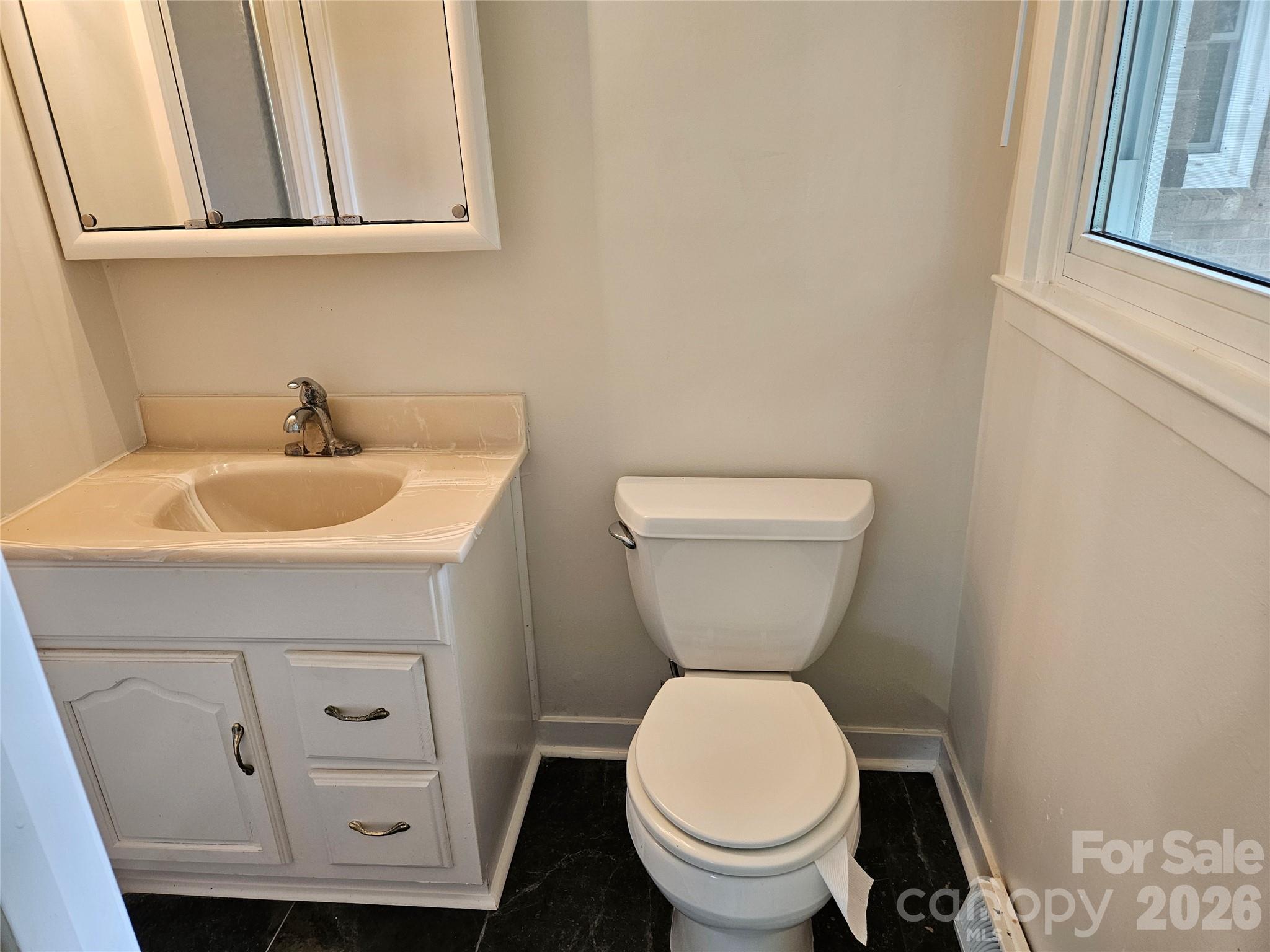 20402 Norton Road Albemarle, NC 28001 - Photo 27 of 34 a bathroom with a toilet sink and mirror