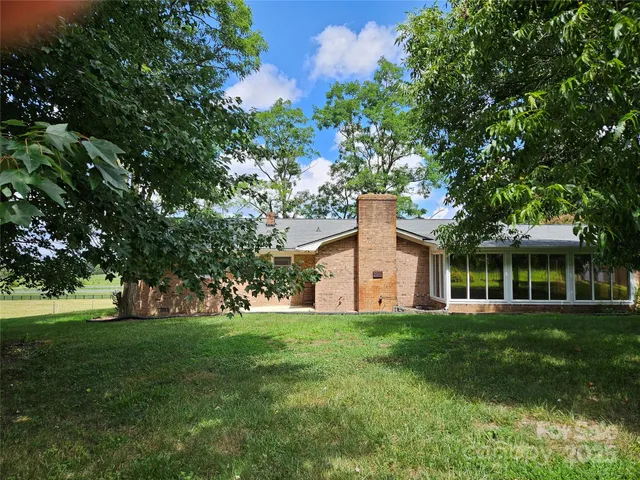 a front view of house with yard and green space