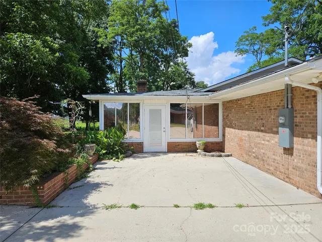 a front view of a house with a garden and plants