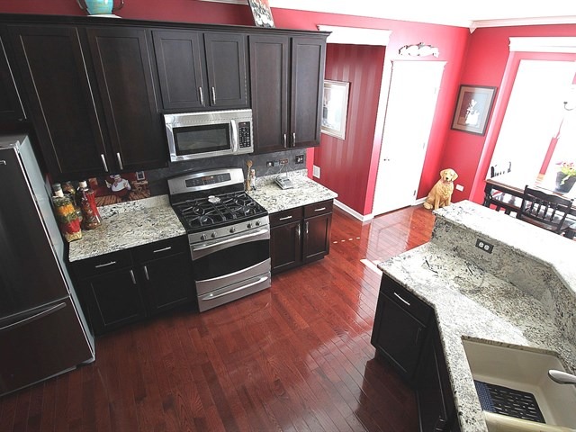 1012 Riviera Drive Elgin, IL 60124 - Photo 7 of 25 a kitchen with a stove and a microwave
